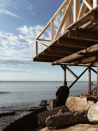 Man looking at sea against sky