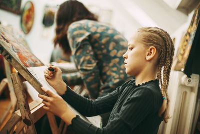 Side view of a boy looking at camera