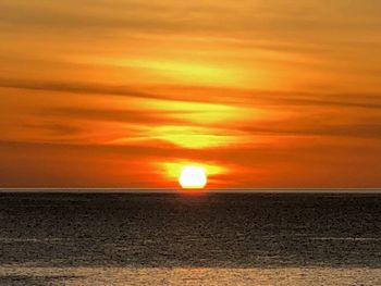 Scenic view of sea against romantic sky at sunset