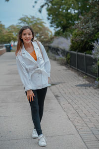 Portrait of young woman walking on street