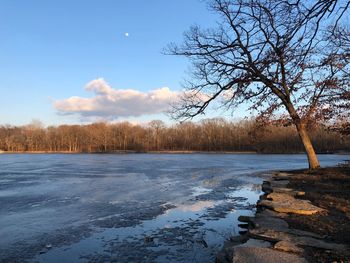 Scenic view of frozen lake against sky during winter