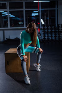 Full length of woman sitting on seat