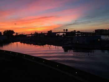 Scenic view of lake against orange sky