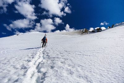 Full length of man skiing on snow covered landscape