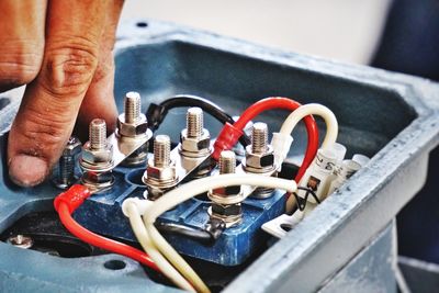 Close-up of manual worker repairing machine