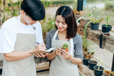 High angle view of friends analyzing succulent plant