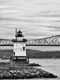 View of bridge over sea against cloudy sky