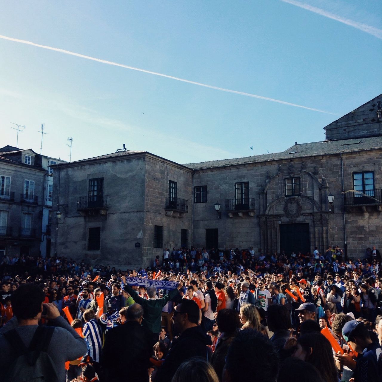 large group of people, crowd, architecture, men, building exterior, lifestyles, built structure, person, leisure activity, sky, togetherness, standing, celebration, mixed age range, outdoors, blue, crowded, city