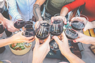 Friends toasting wine at table