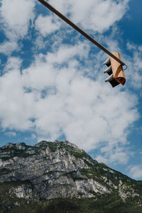 Low angle view of hanging from tree against sky