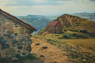 Panoramic view of houses and mountains against sky