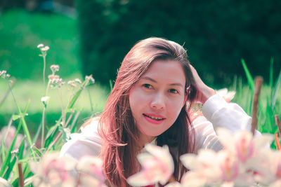 Portrait of smiling young woman at park