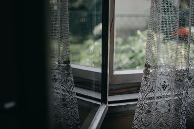 Curtain reflecting in glass window