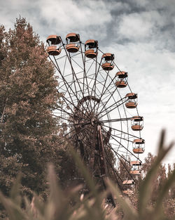 Low angle view of ferris wheel against sky