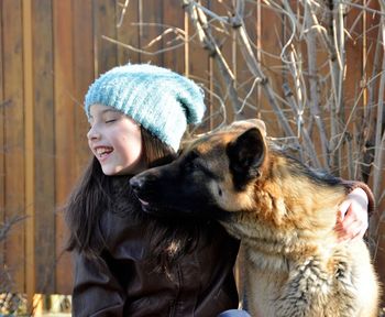 Close-up of dog sticking out tongue on snow