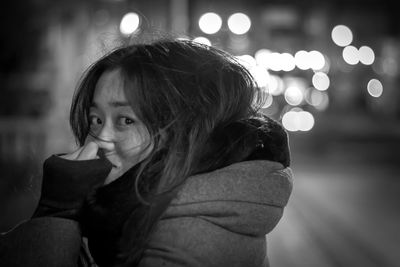 Young woman looking away at night