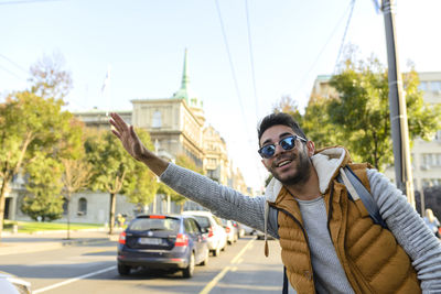 Portrait of smiling young man gesturing on