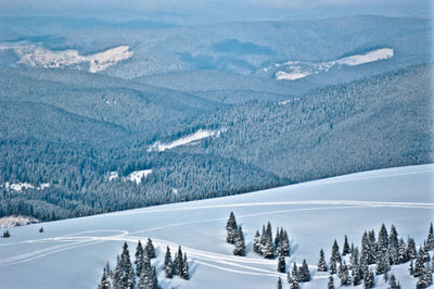 Panoramic view of people on snowcapped mountain against sky