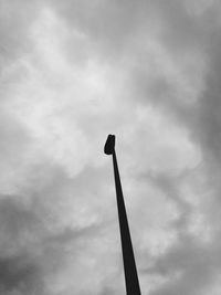 Low angle view of street light against cloudy sky