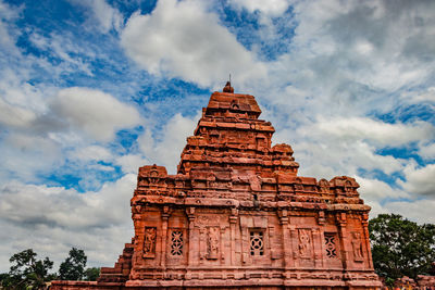 Low angle view of temple building against cloudy sky