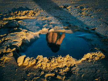 High angle view of reflection of rocks in sea