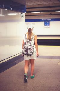 Rear view of woman standing in bus