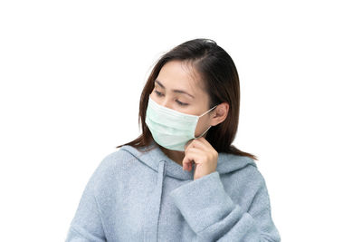 Portrait of a young woman covering face