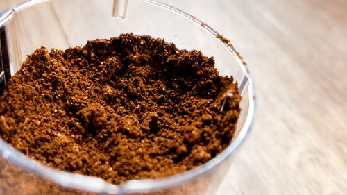 Close-up of ground coffee in container on table