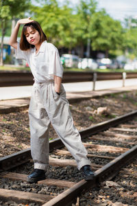 Young woman standing on railroad track