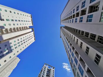 Low angle view of modern buildings against clear blue sky