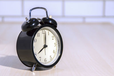 Close-up of clock on table at home