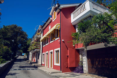 Herceg novi, street with red private house and people in montenegro