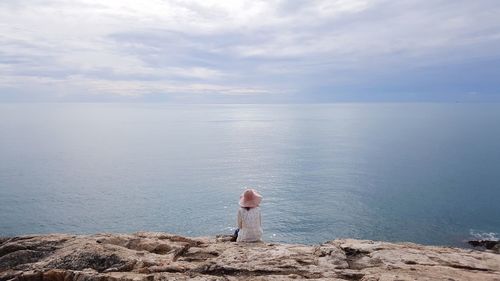 Rear view of woman standing on beach