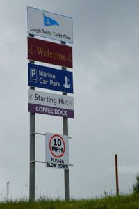 Information sign on field against sky