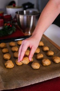 Midsection of person having cookies at home