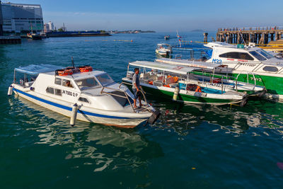 Boats moored in sea against sky