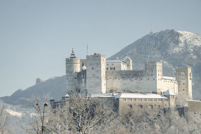 Snow covered fortress hohensalzburg above salzburg, austria