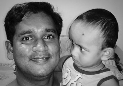 Portrait of father with baby at home