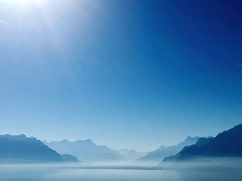 Scenic view of mountains against blue sky