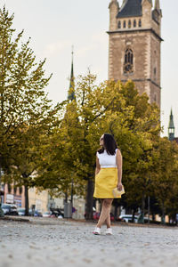 Full length rear view of woman walking in park