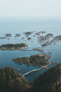 High angle view of rocks by sea against sky