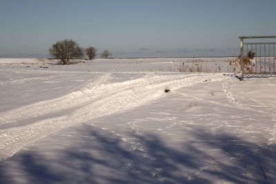 Snow covered field against sky