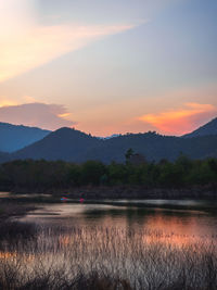 Scenic view of lake against orange sky