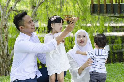 Side view of two people standing outdoors