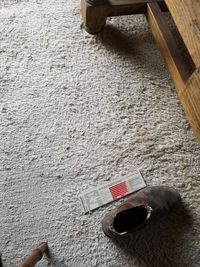 High angle view of coffee cup on rug