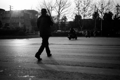 Silhouette people walking on street in city