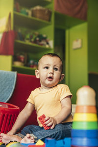 Portrait of cute baby boy sitting at table