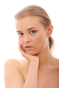 Close-up portrait of a serious young woman over white background