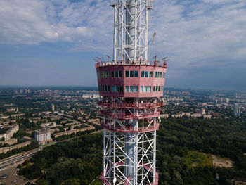 Crane by building against sky