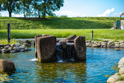 View of wooden posts on rocks